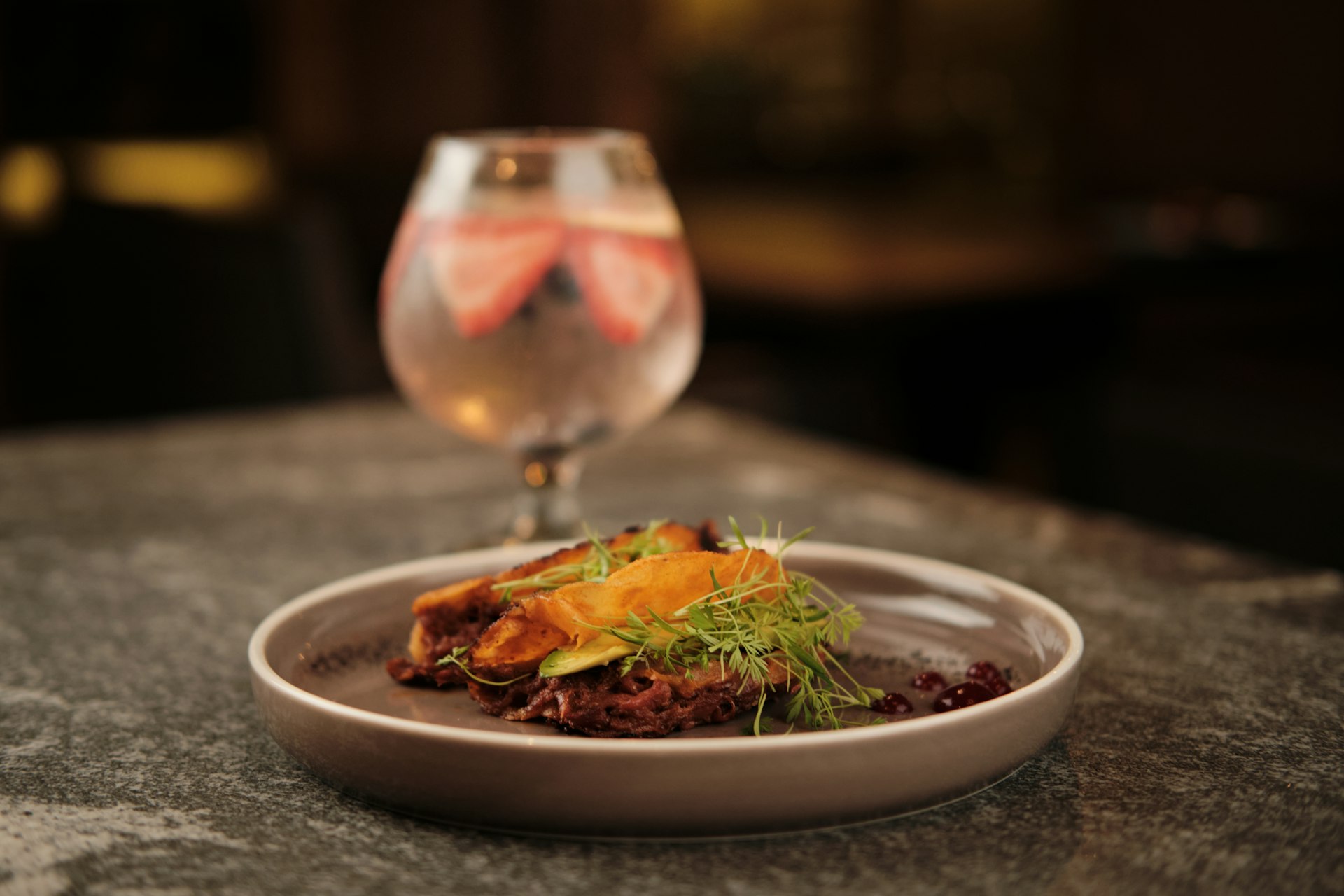 a plate of food and a glass of wine on a table